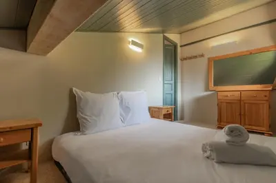 a bedroom with a bed with a towel on it at Le Mont Joux - Vue montagne in Saint-Gervais-les-Bains