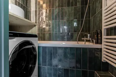 a washing machine in a bathroom with a sink at Le Mont Joux - Vue montagne in Saint-Gervais-les-Bains