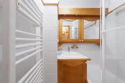 a bathroom with a sink and a mirror at Tete Rousse - Ski aux pieds - Piscine - Terrace in Les Houches