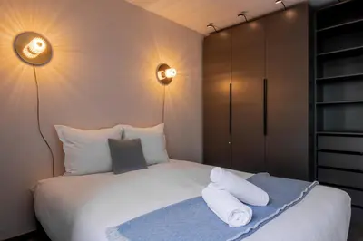a bedroom with a bed with towels on it at Appt Cosy - Vue Mont-Blanc en hyper centre in Chamonix-Mont-Blanc