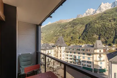 a balcony with a view of a mountain at Appt Cosy - Vue Mont-Blanc en hyper centre in Chamonix-Mont-Blanc