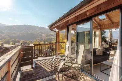 a balcony with chairs and a view of the mountains at Au coin du feu - Terrasse - Vue Mont Blanc in Saint-Gervais-les-Bains
