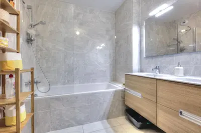 a bathroom with a bath tub and a sink at Mountain Lodge 204 - 90m2 - à côté du télésiège in Saint-Gervais-les-Bains