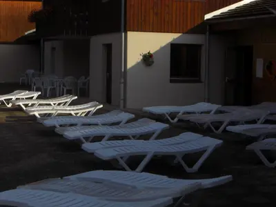 a row of chaise lounges are lined up against a building at APPARTEMENT 6 Personnes SAMOENS in Samoëns