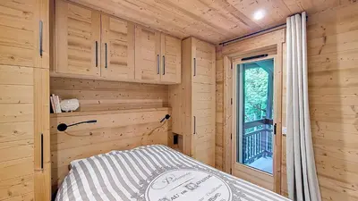 a bedroom of a tiny house with a bed at 1 Gentil Homme in Megève