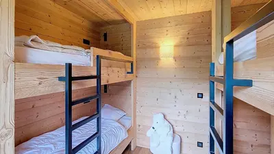 a bedroom with two bunk beds in a cabin at 1 Gentil Homme in Megève