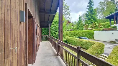 a building with a fence next to a driveway at 1 Gentil Homme in Megève