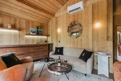 a living room with a couch and a table at Chalet L'Écrin de Megève in Megève