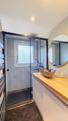 a bathroom with a counter with a sink and a mirror at 1 Clos des Mourets C2 in Megève