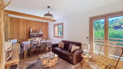 a living room with a couch and a table at 1 Chalet de Rochebrune B in Megève