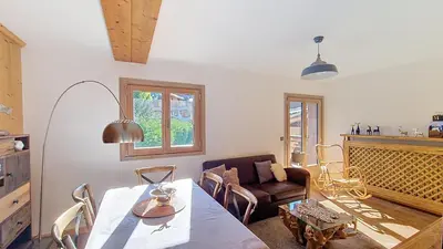 a living room with a table and a couch at 1 Chalet de Rochebrune B in Megève