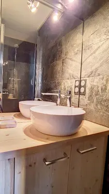a bathroom with two white sinks on a counter at 1 Chalet de Rochebrune B in Megève
