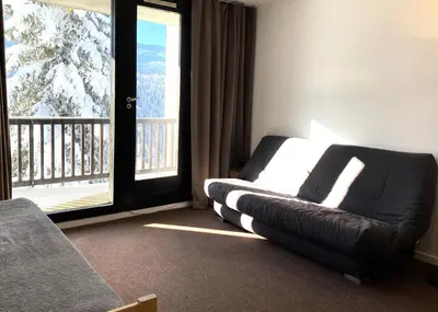 a room with a bed and a balcony with a window at Résidence Capricorne - maeva Home - Studio 4 Personnes - Budget MAE-3836 in Flaine