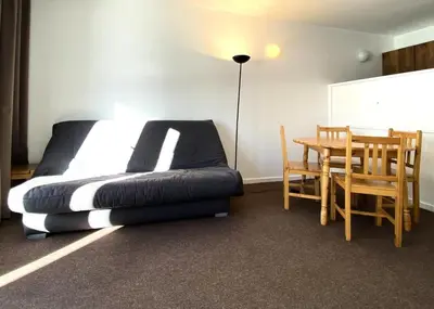a bedroom with a bed and a table and a dining room at Résidence Capricorne - maeva Home - Studio 4 Personnes - Budget MAE-3836 in Flaine