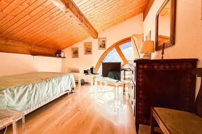 a bedroom with a bed and a large window at Stay in the heart of Chamonix-Mont-Blanc in Chamonix-Mont-Blanc