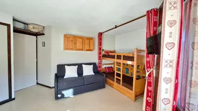 a living room with a couch and a bunk bed at Appartement Samoens village in Samoëns