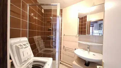 a bathroom with a toilet and a sink and a shower at Appartement Samoens village in Samoëns