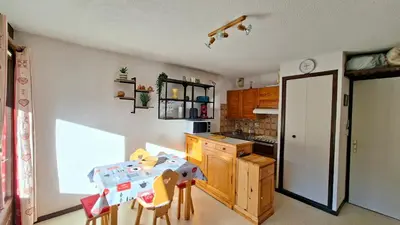 a kitchen with a table and chairs in a room at Appartement Samoens village in Samoëns