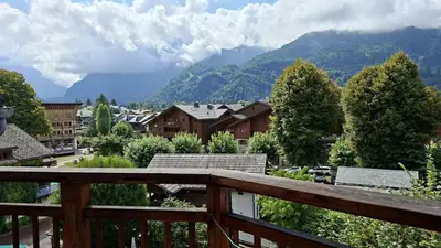 a view from a balcony of a town with mountains at Appartement Samoens village in Samoëns