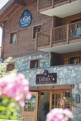 a building with a sign in front of it at CGH Résidence Boutique Les Chalets De Laÿssia in Samoëns