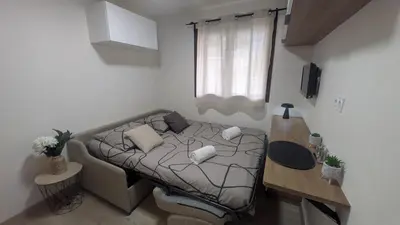 a small room with a bed and a table at Studio La Vallée Blanche in Sallanches