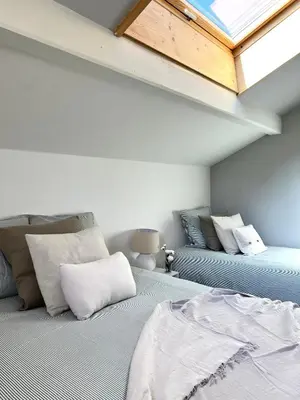 a attic room with a bed and a skylight at Appartement Champêtre - Terrasse, Vue & Parking by AlpenlySallanches in Domancy