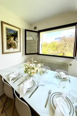 a white table with chairs and a large window at Appartement Champêtre - Terrasse, Vue & Parking by AlpenlySallanches in Domancy