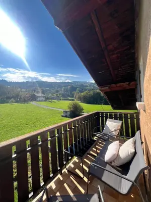 a balcony with chairs and a view of a field at Appartement Champêtre - Terrasse, Vue & Parking by AlpenlySallanches in Domancy