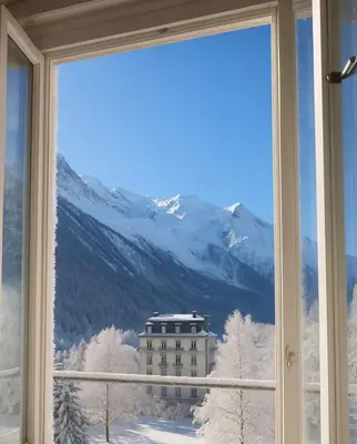 a window with a view of a building in the snow at Alpine stay right in the center of Chamonix in Chamonix-Mont-Blanc