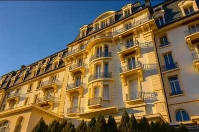 a yellow building with balconies and trees at Alpine stay right in the center of Chamonix in Chamonix-Mont-Blanc