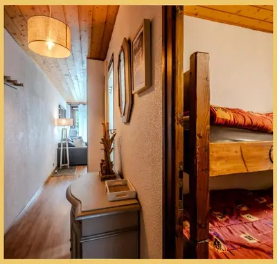 a room with two bunk beds and a desk at L'Aiguille de Chamonix I Appartement Les Praz in Chamonix-Mont-Blanc