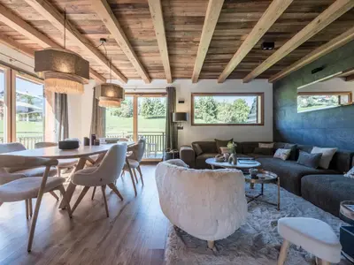 a living room with a couch and a table at Chalet Zazen I Le Chalet Club in Combloux