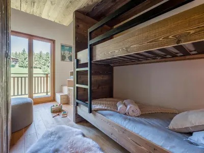 a bedroom with a large wooden bunk bed at Chalet Zazen I Le Chalet Club in Combloux