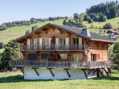a log house with a balcony and a deck at Chalet Zazen I Le Chalet Club in Combloux