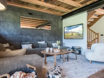 a living room with a couch and a table at Chalet Zazen I Le Chalet Club in Combloux