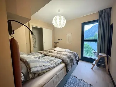 a bedroom with a bed and a large window at Elba, Les Mazots de Kayla in Les Houches