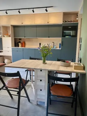 a kitchen with a wooden table and two chairs at Elba, Les Mazots de Kayla in Les Houches