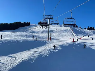 a group of people skiing down a snow covered ski slope at Elba, Les Mazots de Kayla in Les Houches