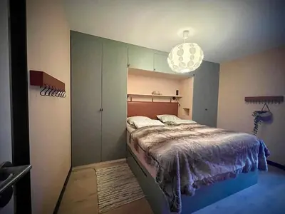a bedroom with a bed and a pendant light at Elba, Les Mazots de Kayla in Les Houches