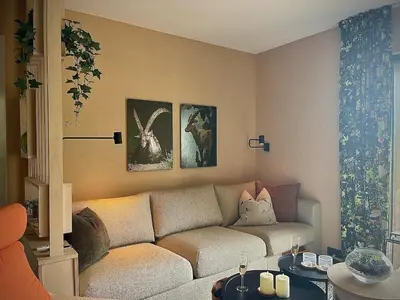 a living room with a couch and two tables at Elba, Les Mazots de Kayla in Les Houches