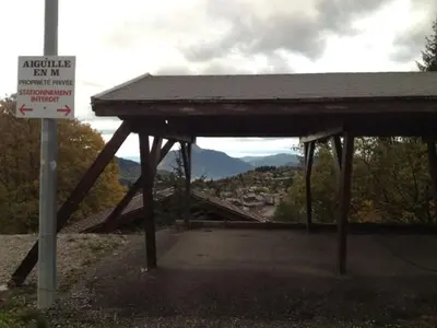 a building with a sign in front of a mountain at 3 Pièces aux Carroz, 6 Pers, Terrasse, Parking - FR-1-572-338 in Arâches-la-Frasse