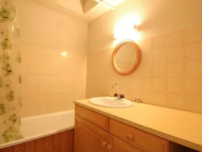 a bathroom with a sink and a tub and a mirror at 3 Pièces aux Carroz, 6 Pers, Terrasse, Parking - FR-1-572-338 in Arâches-la-Frasse