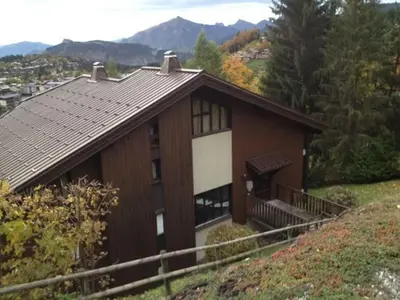 a house on a hill with mountains in the background at 3 Pièces aux Carroz, 6 Pers, Terrasse, Parking - FR-1-572-338 in Arâches-la-Frasse