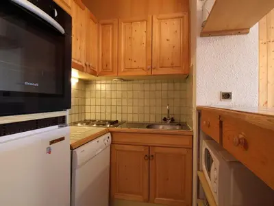 a kitchen with wooden cabinets and a sink at 3 Pièces aux Carroz, 6 Pers, Terrasse, Parking - FR-1-572-338 in Arâches-la-Frasse