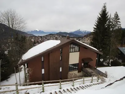 a house in the snow with mountains in the background at 3 Pièces aux Carroz, 6 Pers, Terrasse, Parking - FR-1-572-338 in Arâches-la-Frasse