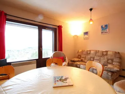 a living room with a table and chairs and a couch at 3 Pièces aux Carroz, 6 Pers, Terrasse, Parking - FR-1-572-338 in Arâches-la-Frasse