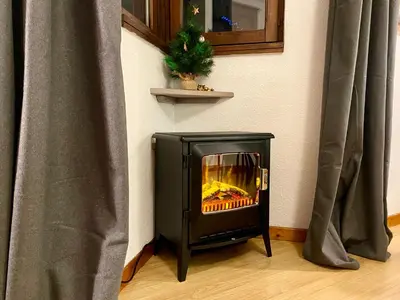 a fireplace sitting on the floor next to a wall at Les Sommets Studio in Chamonix-Mont-Blanc