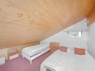 a bedroom with two beds and a wooden ceiling at BA229 - 2 pieces mezzanine 6 pers pied de pistes in Les Carroz d'Araches