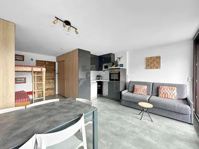 a living room with a couch and a table at PLAT113 - Studio 4 pers centre station Carroz in Les Carroz d'Araches