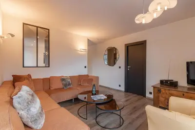 a living room with a couch and a table at Quartz - Appt 4 etoiles vue Mont-Blanc - Centre in Chamonix-Mont-Blanc